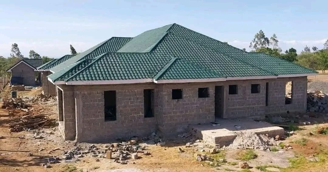 Kenyan home being roofed with Maisha Mabati green tile profile sheets